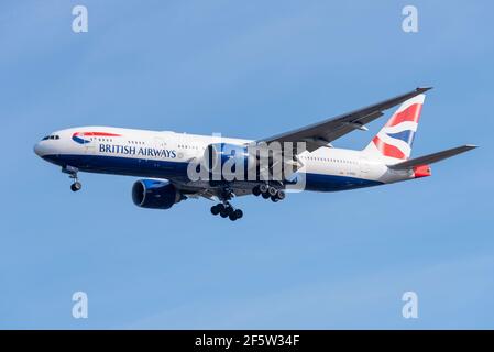 British Airways Boeing 777 236 Extended Range jet airliner plane G-RAES on finals to land at London Heathrow Airport, UK, in blue sky. GE90 engines Stock Photo