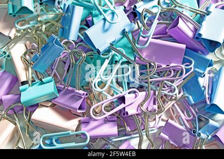 Multicolored paper clips on a light background Stock Photo