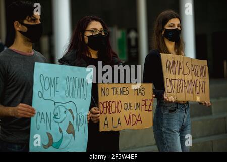 Barcelona, Spain. 28th Mar, 2021. Animal activists with their placards protest for animal rights in front of the Aquarium in Barcelona's Port Vell Credit: Matthias Oesterle/Alamy Live News Stock Photo