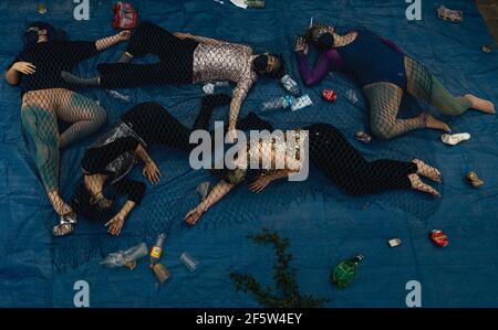 Barcelona, Spain. 28th Mar, 2021. Animal activists protest under a fishing net for animal rights in front of the Aquarium in Barcelona's Port Vell Credit: Matthias Oesterle/Alamy Live News Stock Photo