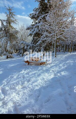 Snow covered picnic table in the park at winter. Snowy park. Winter background photo. Stock Photo