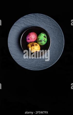 Coloured quail eggs in small bowls, Easter eggs, Germany Stock Photo