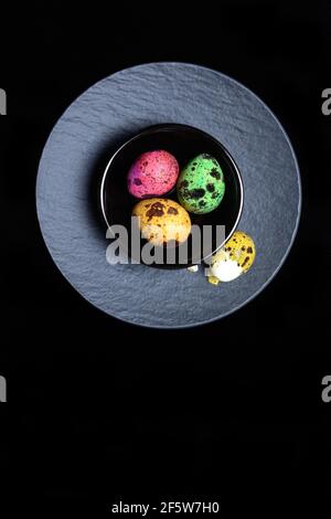 Coloured quail eggs in small bowls, Easter eggs, Germany Stock Photo