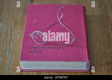 vintage glasses 100 years old on the book Stock Photo