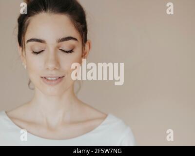 Young woman with closed eyes, smiling Stock Photo