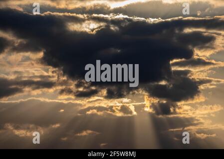 Sun behind dark clouds, evening sun, Germany Stock Photo