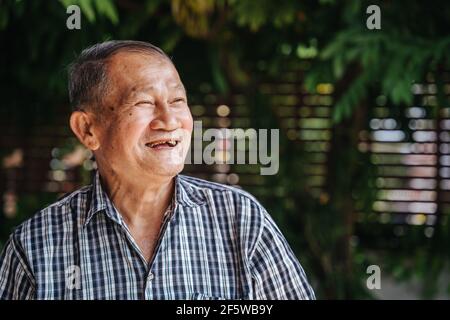 close-up portrait of happy asian senior man look with hope. Old thai man, Healthy senior concept Stock Photo