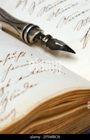 Pen with nib on book, old writing, ink, diary Stock Photo