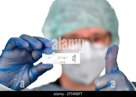 Medical staff shows negative antigen rapid test, thumbs up, gestures, test cassette, Corona crisis, Germany Stock Photo