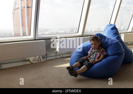 The child sitting on the bean bag Stock Photo