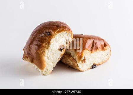 Two sweet buns with raisins on a white background, isolated. Close-up with a copy space for the text. Fresh baked goods for breakfast. Horizontal orie Stock Photo