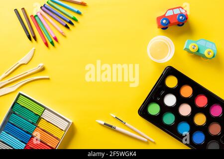 Frame with school supplies on yellow background Stock Photo