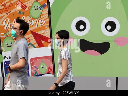 Hong Kong, China. 28th Mar, 2021. Pedestrians wearing face masks are seen in Hong Kong, south China, March 28, 2021. Hong Kong reported zero local infection of COVID-19 for the second straight day on Sunday. The Center for Health Protection said in a statement that only one imported case was found during the past 24 hours ending the midnight of Saturday, dropping further from six imported cases the previous day. The COVID-19 tally in Hong Kong stood at 11,446 on Sunday. Credit: Li Gang/Xinhua/Alamy Live News Stock Photo