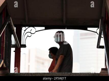 Hong Kong, China. 28th Mar, 2021. Pedestrians wearing face masks are seen in Hong Kong, south China, March 28, 2021. Hong Kong reported zero local infection of COVID-19 for the second straight day on Sunday. The Center for Health Protection said in a statement that only one imported case was found during the past 24 hours ending the midnight of Saturday, dropping further from six imported cases the previous day. The COVID-19 tally in Hong Kong stood at 11,446 on Sunday. Credit: Li Gang/Xinhua/Alamy Live News Stock Photo