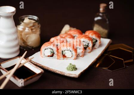 Sushi set with salmon and avocado on a clay plate Stock Photo