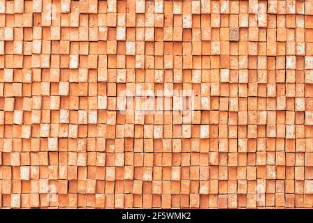Rectangular orange bricks random pattern wall facade texture material in architecture exterior and interior. Stock Photo