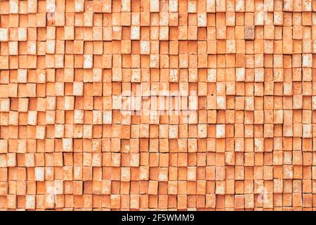 Rectangular orange bricks random pattern wall facade texture material in architecture exterior and interior. Stock Photo