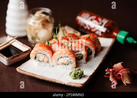 Red dragon sushi with caviar, avocado and salmon Stock Photo