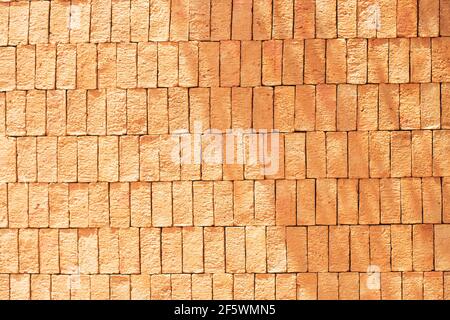 Rectangular orange bricks random pattern wall facade texture material in architecture exterior and interior. Stock Photo