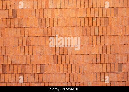 Rectangular orange bricks random pattern wall facade texture material in architecture exterior and interior. Stock Photo