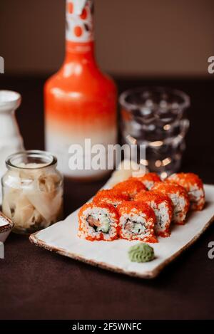 Beautifully served sushi rolls with caviar, cucumber on a clay plate Stock Photo