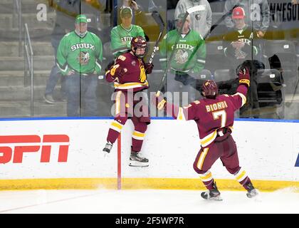 Minn. 27th Mar, 2021. Duluth forward Luke Mylymok (24) jumps to the glass in celebration after scoring the game winning goal in the fifth overtime of the championship game of the NCAA men's hockey Midwest Regional between the University of Minnesota - Duluth Bulldogs and the University of North Dakota Fighting Hawks at Scheels Arena, Fargo, ND. The game went to 5 overtimes and is the longest game ever played in NCAA tournament play. Minnesota Duluth won 3-2 and moves on to the Frozen Four. Photo by Russell Hons/CSM/Ģ����ý Live News Stock Photo