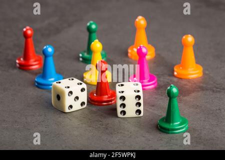 Game pieces with dices on slate Stock Photo