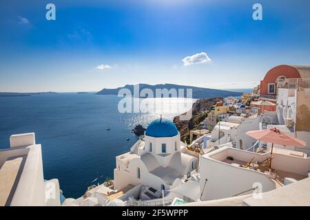 Amazing panoramic landscape, luxury travel vacation. Oia town on Santorini island, Greece. Traditional and famous houses and churches with blue domes Stock Photo