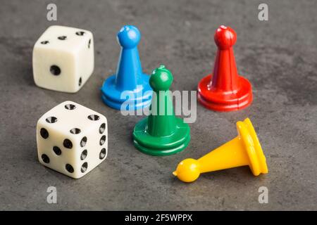 Game pieces with dices on slate Stock Photo