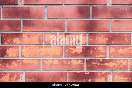 Background of vintage old damaged dirty brick wall with peeling plaster, aged texture concept Stock Photo