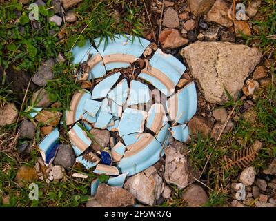Close-up photography of a broken ceramic plate on the ground in a farm near the colonial town of Villa de Leyva, Colombia. Stock Photo