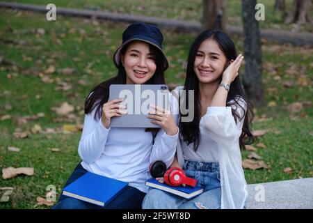 Two students are sitting in university during break and communication. Study, education, university, college, graduate concept. Stock Photo
