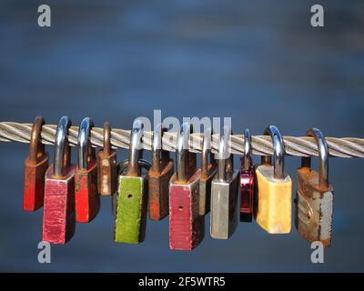 Macro of many love locks at a fence Stock Photo