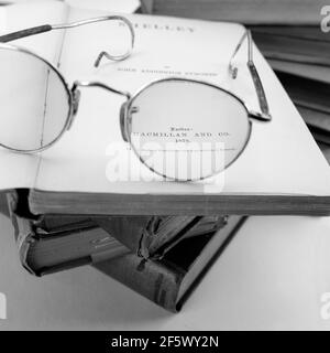Black & White Rare old Vintage books from library Shelley poems, top of an old eyewear glasses on white background Stock Photo