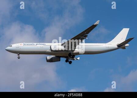 Brussels Airlines Airbus A330 jet airliner plane OO-SFH on finals to land at London Heathrow Airport, UK, in blue sky. Flag carrier of Belgium Stock Photo