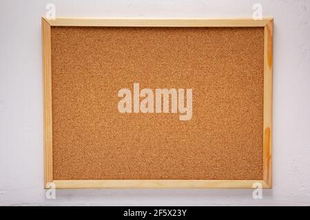 cork board or corkboard at white concrete or putty  wall background texture surface Stock Photo