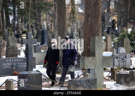 Elderly couple on a Saturday stroll at Hietaniemi cemetery in Helsinki, Finland Stock Photo