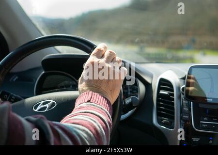 Car interior image and closed up hand of old man drive his car. Stock Photo