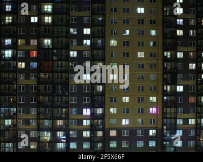 blinking windows of the building at night Stock Photo