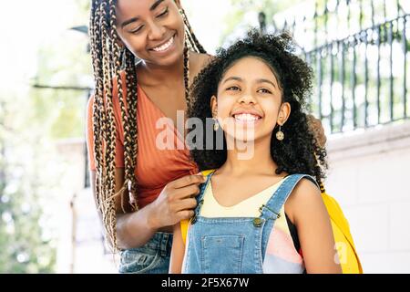 Mother taking her daughter to the school. Stock Photo