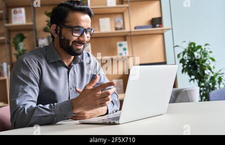 Happy indian business man remote teacher giving distance learning class. Stock Photo