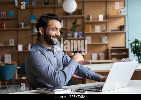 Happy indian man having video conference call virtual business meeting. Stock Photo