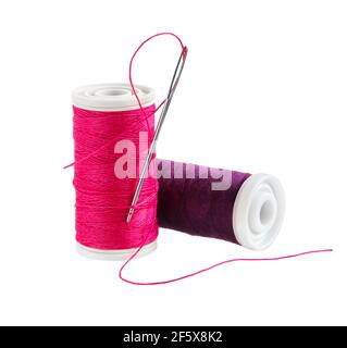 Spool of thread with needle isolated on white background. Sewing thread and needle. Stock Photo