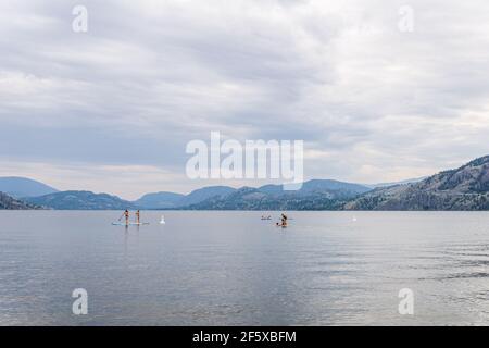 PENTICTON, CANADA - JULY 3, 2020: recreation time paddle boarding on scenic peaceful mountain lake Stock Photo