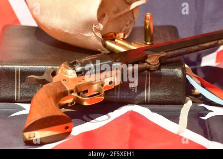 The Holy Bible, bull scrotum, bullets, and revolver on the rebel flag Stock Photo