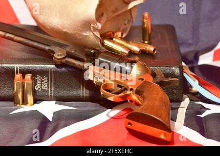 The Holy Bible, bull scrotum, bullets, and revolver on the rebel flag Stock Photo