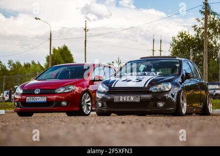 Moscow, Russia - July 06, 2019: Two Volkswagen Golf red and black. Tuned and stock, factory unchanged. Tuned car with lowered suspension and custom wheels. Air suspension Stock Photo