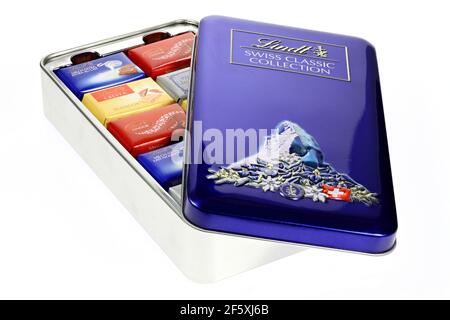 metal box with various Lindt chocolate bars isolated on white background Stock Photo
