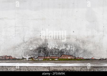 Abstract grungy interior, concrete floor and old red brick wall with damaged white stucco, background photo texture Stock Photo