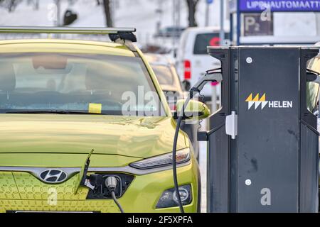 Helsinki, Finland - January 15, 2021: Electric Hyundai Kona is charging on the car parking from Helen charge station. Stock Photo